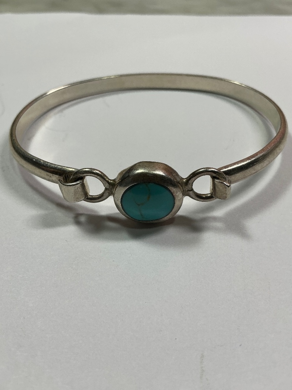 Sterling Silver Mexican Hinged Bracelet with a Turquoise Stone. 2.5” across